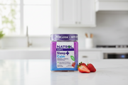 NATROL Sleep + Calm supplement jar with purple and blue design on a white background